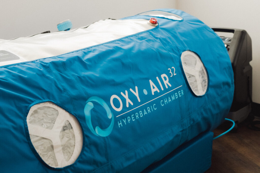 blue hyperbaric chamber with words "Oxy Air 32"