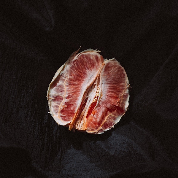 center of peeled citrus fruit resembling a vulva